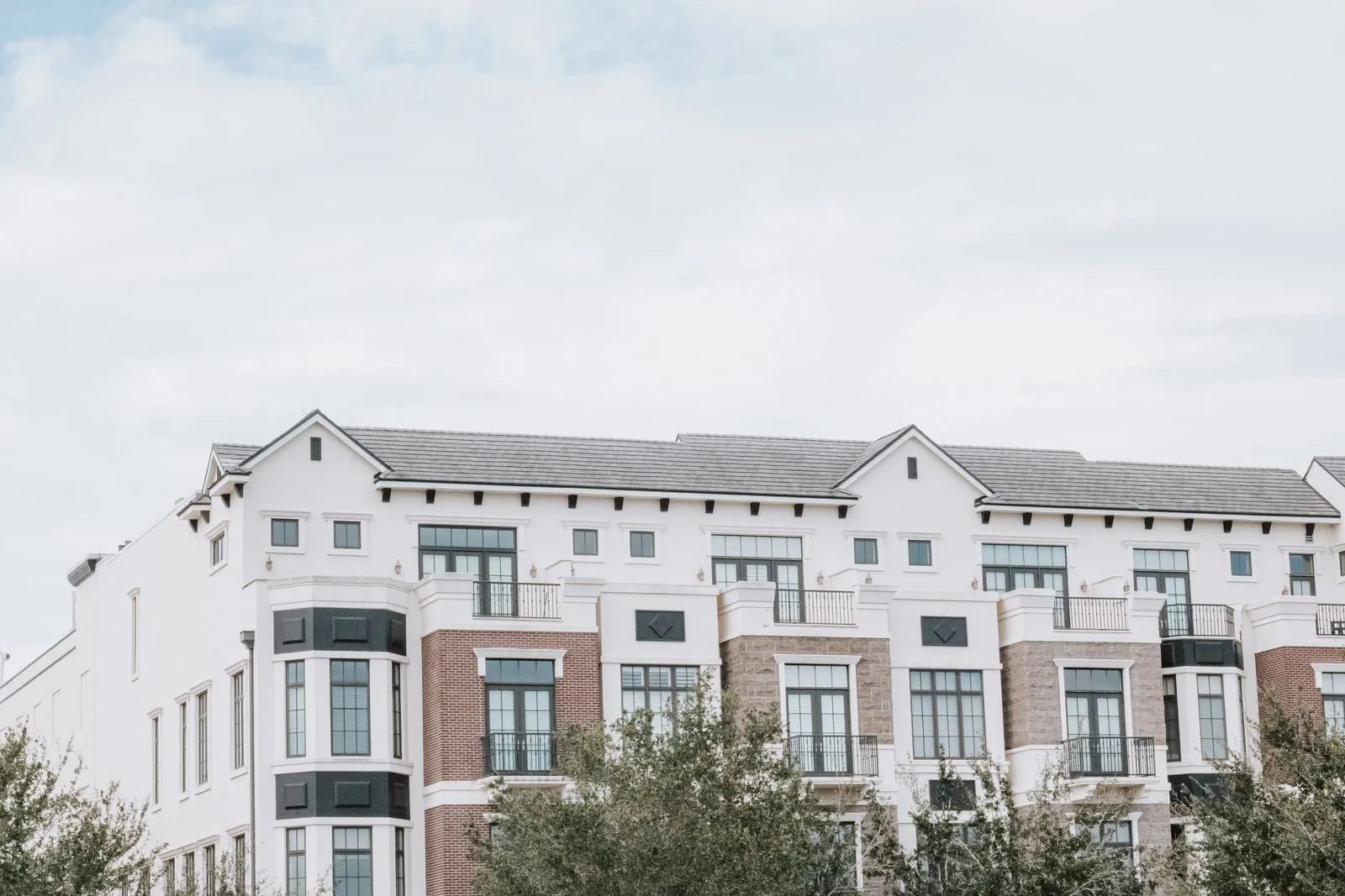 Exterior facade of a multi-story apartment building, illustrative of HUD-assisted multifamily housing